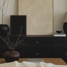 Load image into Gallery viewer, Dark wooden dresser with decorative items including a vase with branches and books.