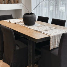 Load image into Gallery viewer, Dining table with a black vase and patterned tablecloth, surrounded by black chairs.