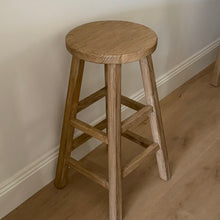 Load image into Gallery viewer, Wooden bar stool against a plain wall on a wooden floor